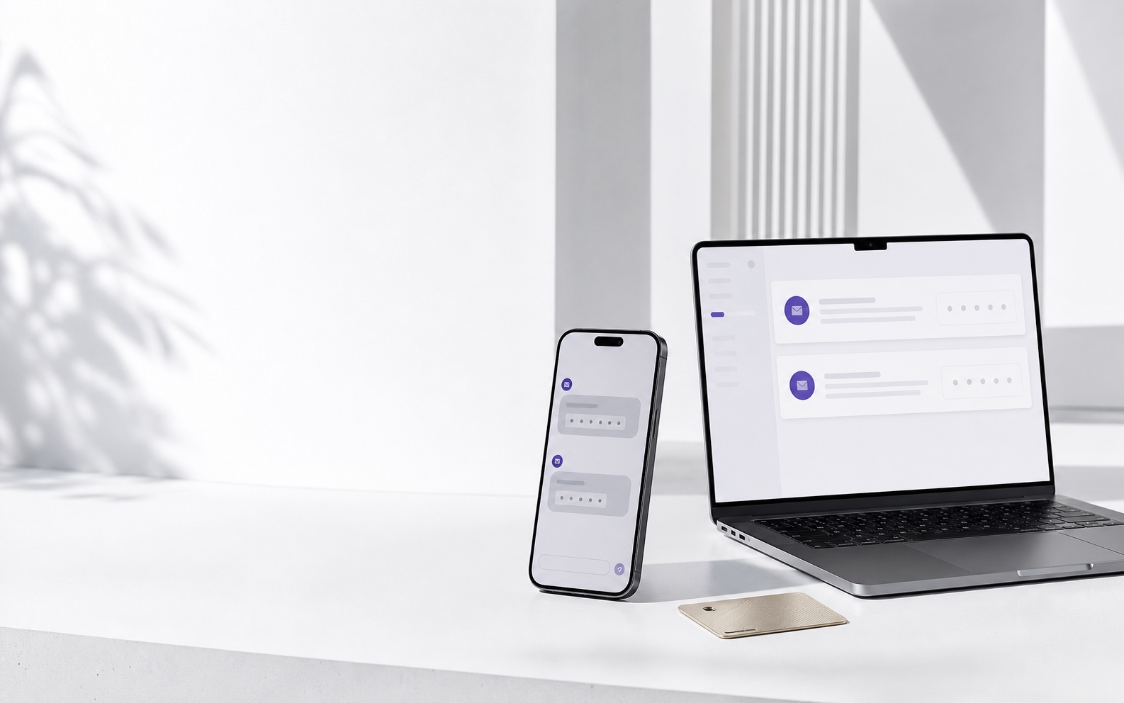 A phone and laptop displaying verification messages in a white studio
